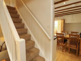 A staircase leading to upper level beside a dining area at Byways Ambleside