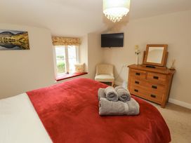 A bedroom with a bed and towels at Byways in Ambleside