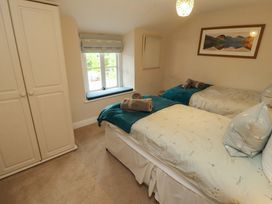 A bedroom with twin beds and a wardrobe at Byways in Ambleside