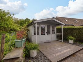 A cottage with a deck and planters at Byways Ambleside