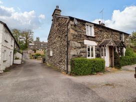 A stone house with a pathway and garden at Byways Ambleside
