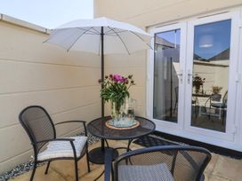 An outdoor seating area with a table and chairs at Seashell Sands in Appledore