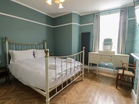 A bedroom with a bed and a dressing table at Noah's Rest in Llandudno