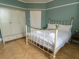 A bedroom with a bed and wardrobe at Noah's Rest in Llandudno