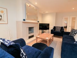 A living room with a television and coffee table at 39 Dart Marina in Dartmouth