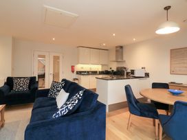 A living room with sofa and dining table at 39 Dart Marina Dartmouth