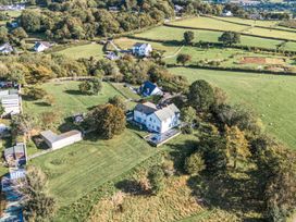 An aerial view of a property with a house and garden at The Manor House Skerry Vore Bryn Pydew near Llandudno Junction