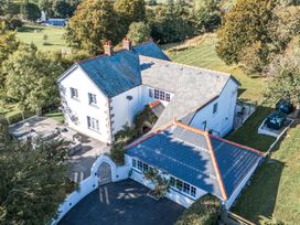 An outdoor area of a house with a garden and patio at The Manor House Skerry Vore Bryn Pydew near Llandudno Junction