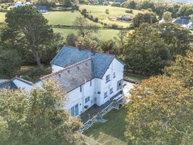 An aerial view of a house with a balcony and yard at The Manor House Skerry Vore Bryn Pydew near Llandudno Junction