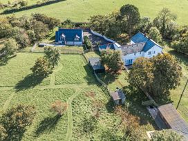 An aerial view of a house with a shed and surrounding grass at The Manor House Skerry Vore in Bryn Pydew near Llandudno Junction