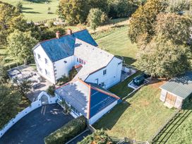 An outdoor view of a house and surrounding yard at The Manor House Skerry Vore Bryn Pydew near Llandudno Junction