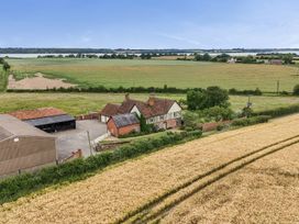 An aerial view of a house and barn in a field at Knights Farm in Harkstead