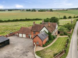 An exterior view of a house with a garage and garden at Knights Farm in Harkstead