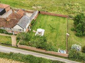An outdoor view of a house and garden area at Knights Farm in Harkstead