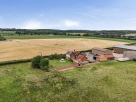 A farm with a house and surrounding fields at Knights Farm in Harkstead