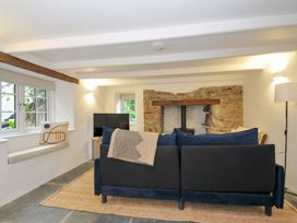 A living room with a sofa and television at Sunrise Cottage St Kew Highway near Wadebridge