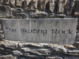 An engraved sign that reads the Skating Rock on a stone wall at The Skating Rock Bunane near Kenmare, County Kerry