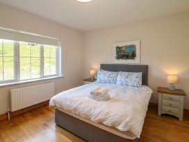 A bedroom with a bed and bedside tables at The Skating Rock in Bunane near Kenmare, County Kerry