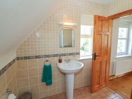 A bathroom with sink and mirror at The Skating Rock in Bunane near Kenmare County Kerry