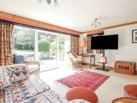 A snug with seating area and television at Temple House in Goonhavern