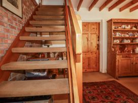 A staircase and wooden door in a hallway at Temple House in Goonhavern