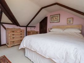 A bedroom with a bed and dresser at Temple House in Goonhavern