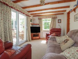 A living room with a sofa and television at Temple House in Goonhavern