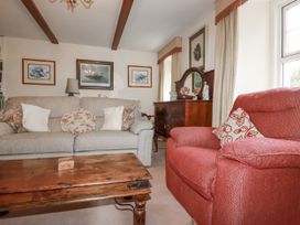 A living room with a sofa and armchair at Temple House in Goonhavern