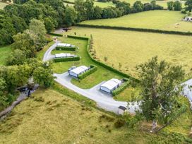 An outdoor area with features including shelters and a stream at Caban Dulas in Rhayader