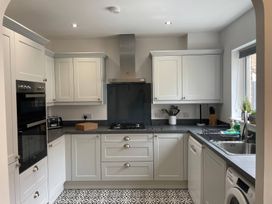 A kitchen with cabinets and appliances at Plain Sailing in Weymouth