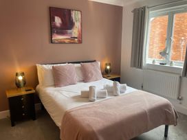 A bedroom with a bed and nightstands at Plain Sailing, Weymouth