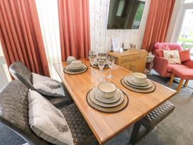 A dining room with a table set for meals at Plot 32 High Hesket near Armathwaite