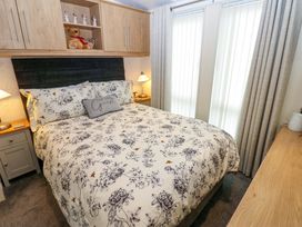 A bedroom with a bed and bedside table at Plot 32 High Hesket near Armathwaite