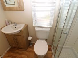 A bathroom with a sink, toilet, and shower at Plot 32 High Hesket near Armathwaite