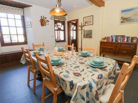 A dining room with a table set for meal at Parrog Stores near Newport, Pembrokeshire