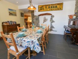 A dining room with a large table and chairs at Parrog Stores Parrog near Newport, Pembrokeshire