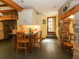 A kitchen with a dining area and a door at Parrog Stores Parrog near Newport, Pembrokeshire
