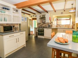 A kitchen with appliances and table at Parrog Stores near Newport, Pembrokeshire