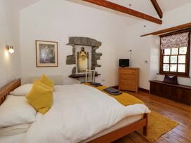 A bedroom with a bed and chest of drawers at Parrog Stores near Newport, Pembrokeshire