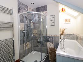 A bathroom with a shower and bathtub at Parrog Stores in Parrog near Newport, Pembrokeshire
