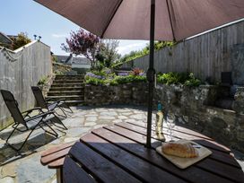 A garden with a table and chairs at Parrog Stores Parrog near Newport Pembrokeshire