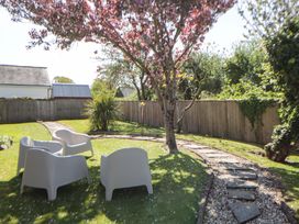 A garden with chairs and a pathway at Parrog Stores, Parrog near Newport, Pembrokeshire