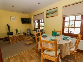A dining room with a table and chairs at Parrog Bach near Newport, Pembrokeshire