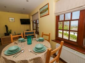 A dining room with a table set for meals at Parrog Bach Parrog near Newport, Pembrokeshire