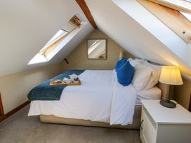 A bedroom with a bed and side table at Parrog Bach near Newport, Pembrokeshire