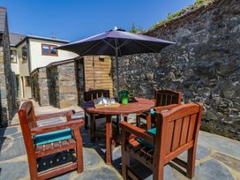 An outdoor seating area with a table and chairs at Parrog Bach near Newport, Pembrokeshire