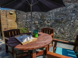 A table with chairs and an umbrella at Parrog Bach Parrog near Newport, Pembrokeshire