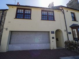 A building exterior with windows and a garage door at Parrog Bach in Parrog near Newport, Pembrokeshire