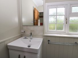 A bathroom with a sink and mirror at Llainorfa in Maenygroes near New Quay