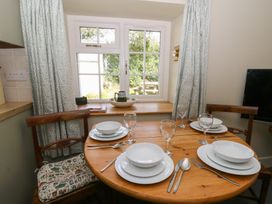 A dining room with a table set for a meal at Llainorfa in Maenygroes near New Quay